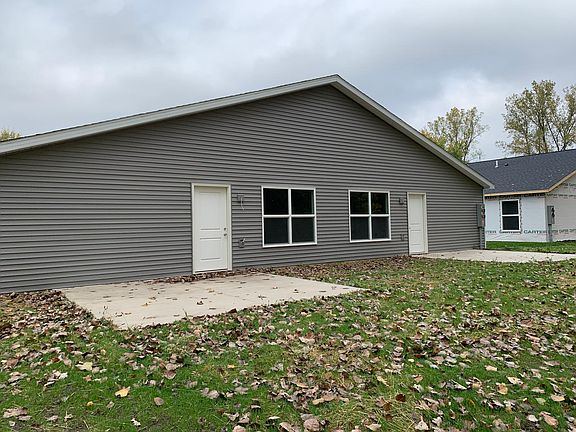 Exterior Back- Back entrance door with a cement patio platform