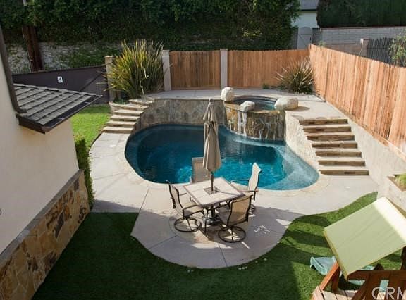 Balcony overlooking pool and backyard