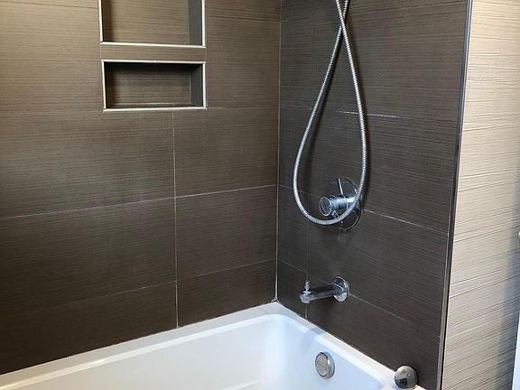 Hallway bathroom with deep soaking tub.