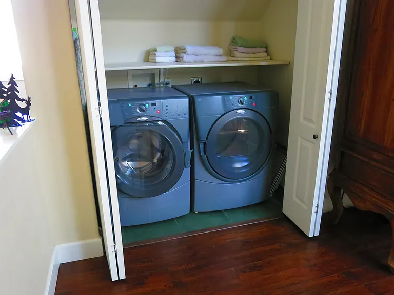 The washer and dryer are located in the closet on the second floor between the bedrooms.