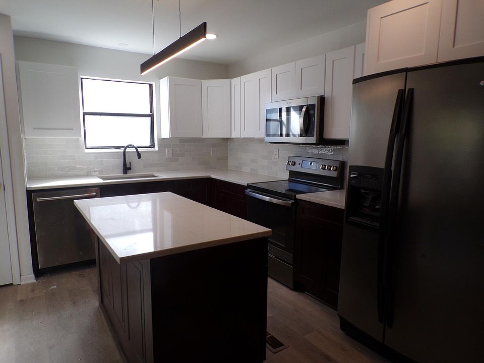 Completely new kitchen with quartz countertops backsplash and appliances