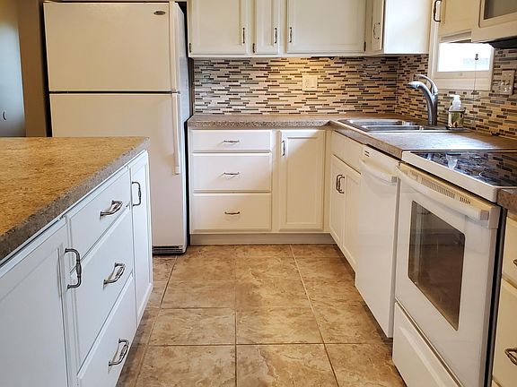 Kitchen with island and under-cabinet lighting.