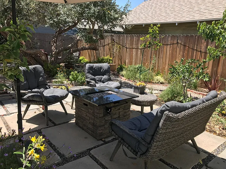 Enjoy this Gorgeous Backyard filled with Fruit Trees, Colorful Flowers, and a Firepit Seating Area as part of your tranquil living experience in this Charming 2 BDR/1 BA Retro Row Duplex Apartment.