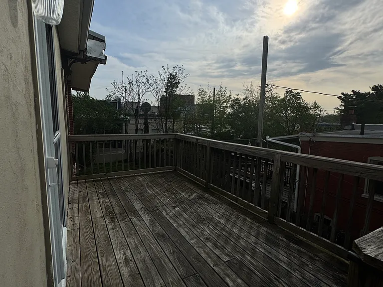 spacious deck overlooking the yard with a fire escape staircase