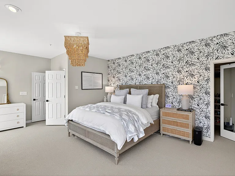 Primary bedroom. Room is very spacious - bed size: California King with 32' W dressers on each side. Location: downstairs. (center light fixture will be removed)