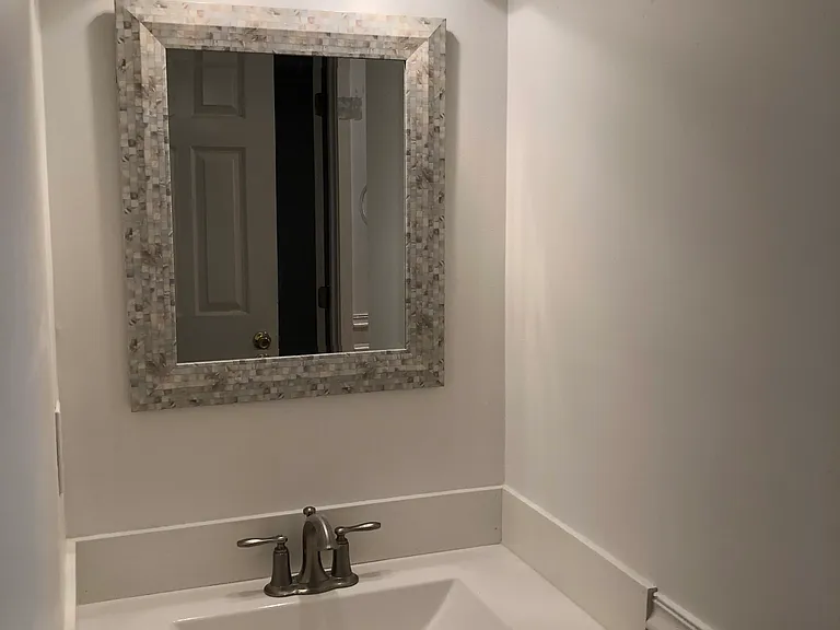 Second bathroom with new vanity, lighting and mother of pearl mirror.