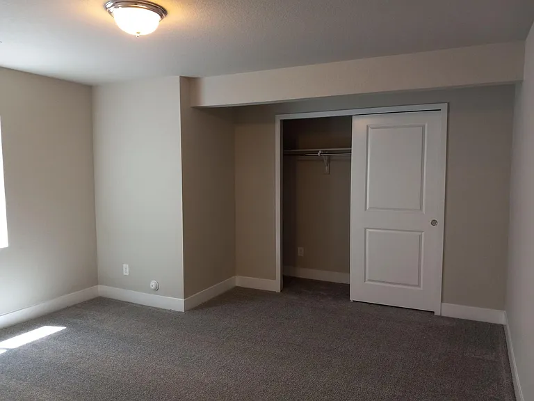 Bedroom 5, again with large window and closet.