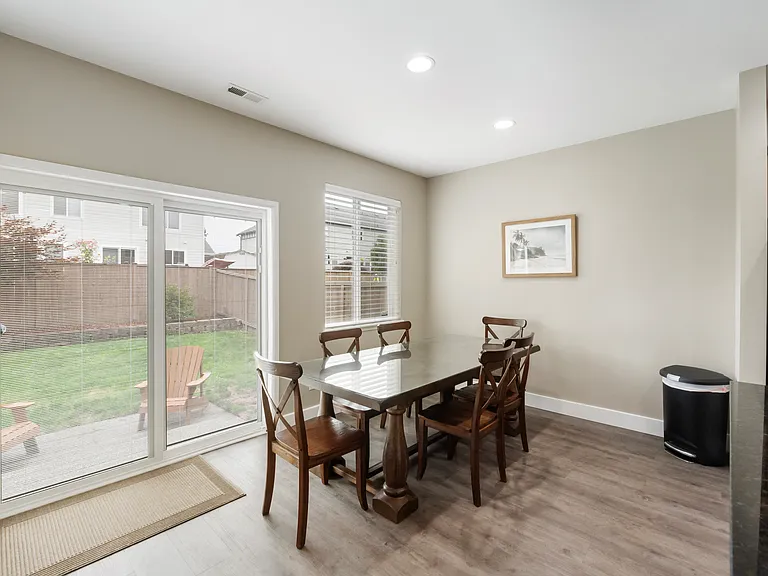 Dining room with sliding door that enters to back patio and backyard - there are blinds in the sliding door for privacy