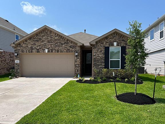 This beautiful home has tons of upgrades including exterior sconces and double flood lights