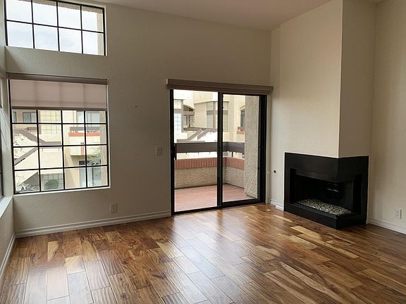 Living room and fireplace. Acacia hardwood. Newly painted throughout. Emtek hardware.