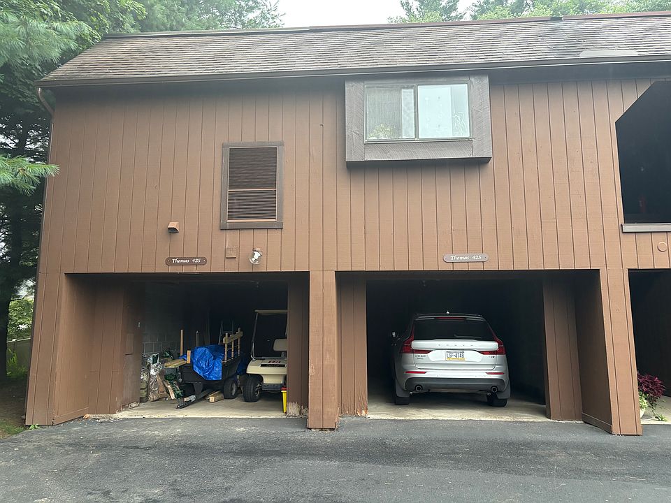 Front view. End unit. Two car garage. 3 storage rooms in front. Golf cart included in renatl!