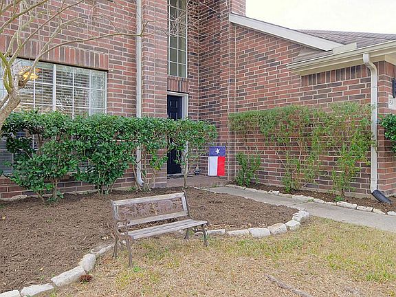 Custom landscaping surrounds this beautiful home.