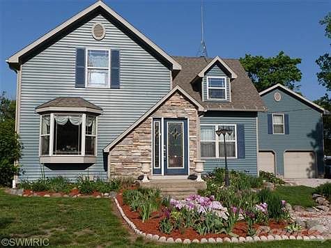 The owner took a lot of pride in re-doing this home, after taking this house completely down to the studs,he added on an addition. There are 4 bedrooms and 2 full baths, kitchen with a large snack bar, kitchen appliances remain, dining room with picture window, living room with a bay window and a gas fireplace, In the family room is a wood/gas stove,sliders to the large covered deck with a stainless Steele gas grill, which also remains.There are beautiful wood floors in the kit.din.liv. and family room. The master  bedroom has vaulted ceilings 2 large closets,sliders to the deck the covered deck, Master bath has a separate area for the lavatory, tiled flooring and tiled shower with a triangle tub. There are 2 foyers to enter the home both have tiled floors. laundry area is tiled as well. There is a big bonus to this home, it has a very nice 3 room,plus bath guest area above the garage, and a great man cave in the 24x30 pole barn.The fenced-in back yard comes with a play gym,and the lar