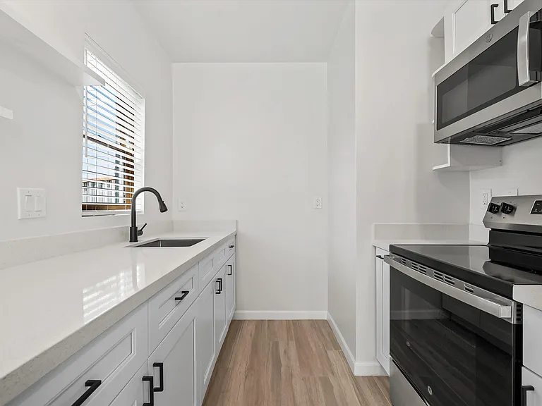 Kitchen with quartz counters and stainless steel appliances
