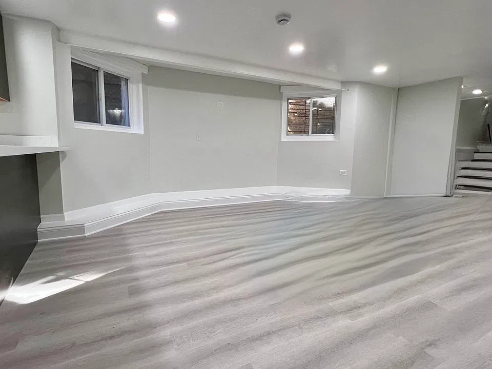 Large bright living room with new floors and dimmable lights