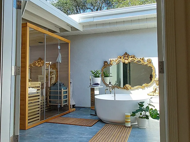 French doors open from bathroom to spa courtyard