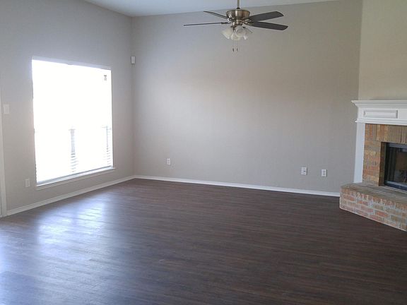 Family room with wood burning fire place, new flooring, ligh