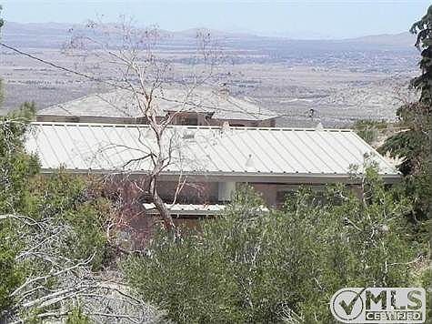 view from rear showing metal roof & spectacular view