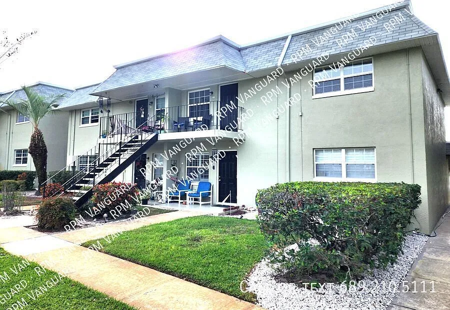 Second Floor Condo Unit with Balcony and Pool View — Photo 1