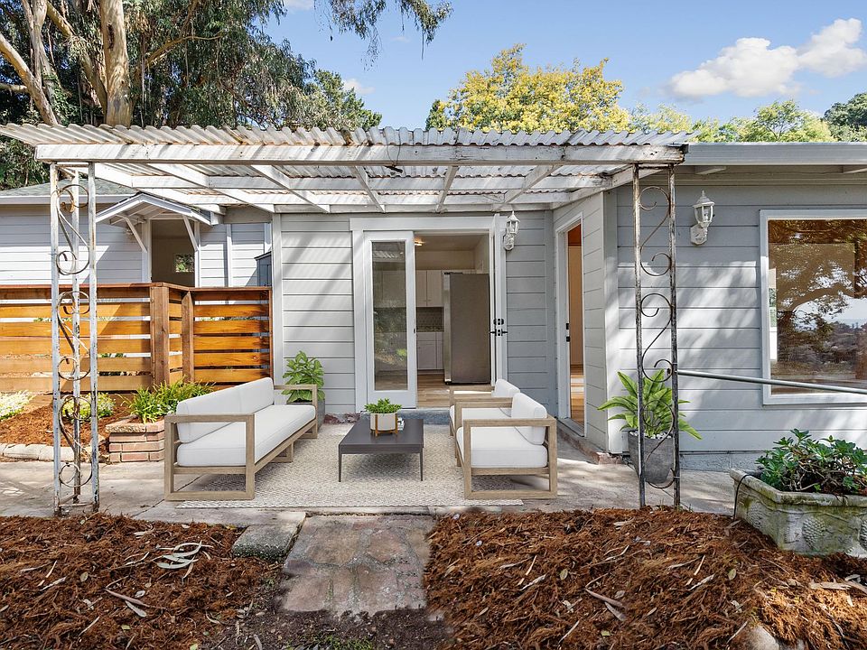 Main door, accessible via path along the side of the house (attached studio unit that is rented separately on the left behind the fence)
