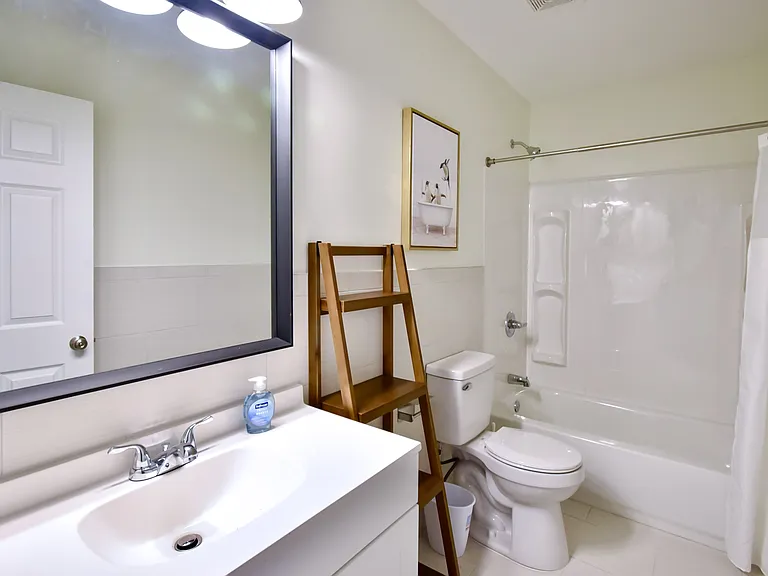 Freshly remodeled with new tub, surround, toiletvanity and floor tile