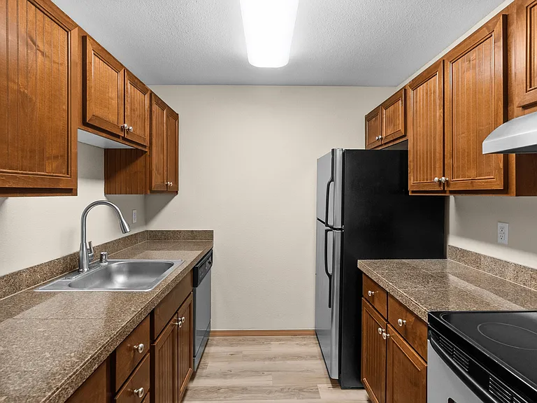 Enjoy cooking in a beautifully updated kitchen featuring sleek countertops, stainless steel appliances, and rich wood cabinetry. Enjoy cooking in a beautifully updated kitchen featuring sleek countertops, stainless steel appliances, and rich wood cabinetr