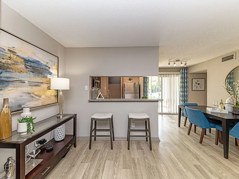 Breakfast bar & dining area with hardwood-style flooring throughout