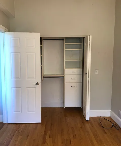 Bedroom features a custom-built closet for ample storage.