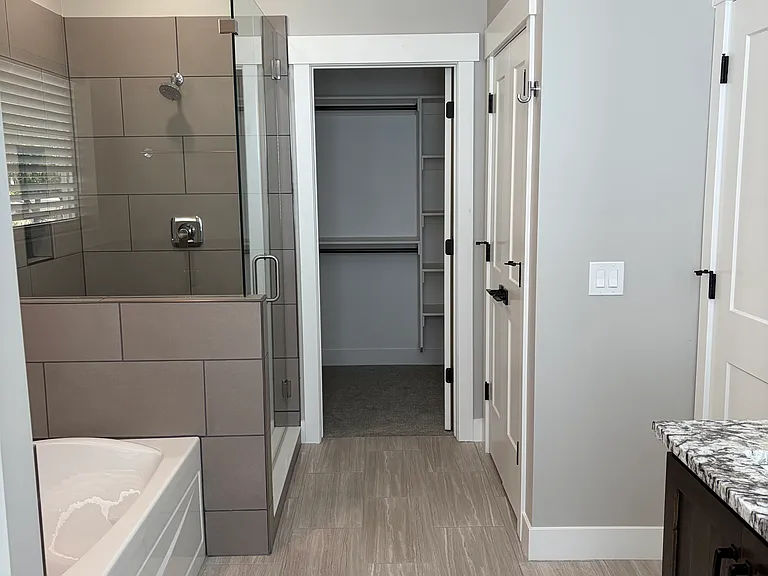 Master bath with large soaker tub and beautiful tile and glass enclosed shower. Separate linen closet.