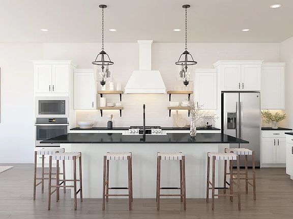 Kitchen with white cabinetry and pendant lights