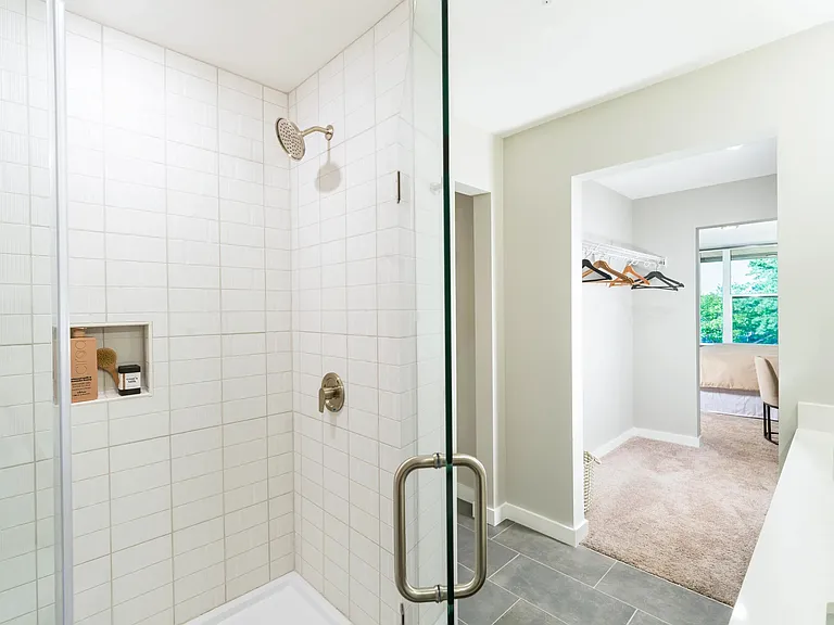 Floor-to-ceiling tile surrounds this spacious shower, creating a sleek, spa-worthy escape.
