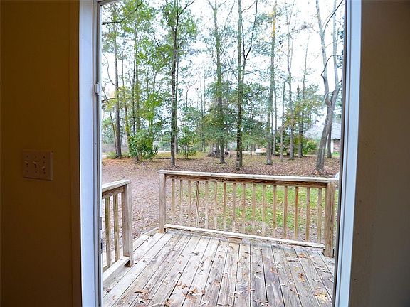 Enjoy the view off this SECOND wood deck at the side door at 40 Williams, Coldspring, TX