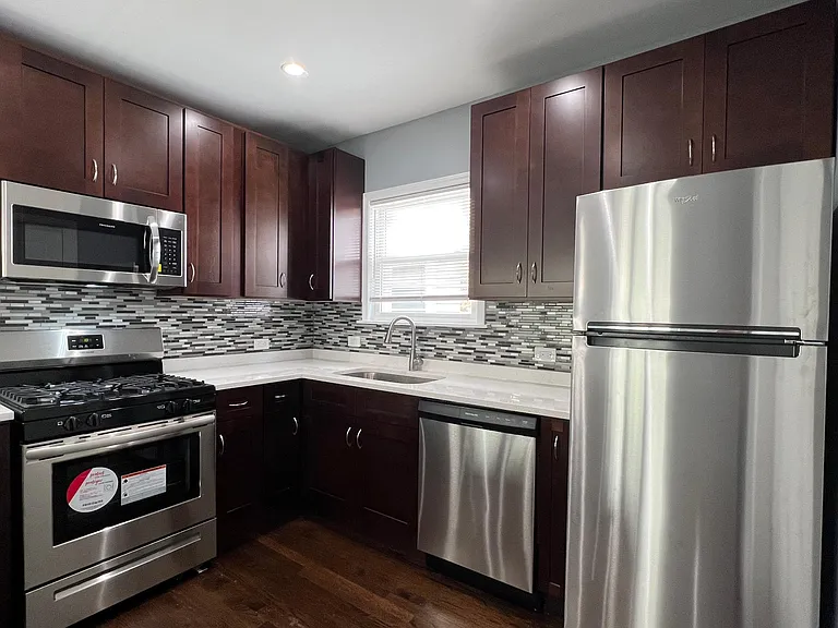 Newly renovated kitchen with 42" express cabinets, brand new stainless steel appliances (including dishwasher), quartz countertops with breakfast bar, and soft-close drawers!