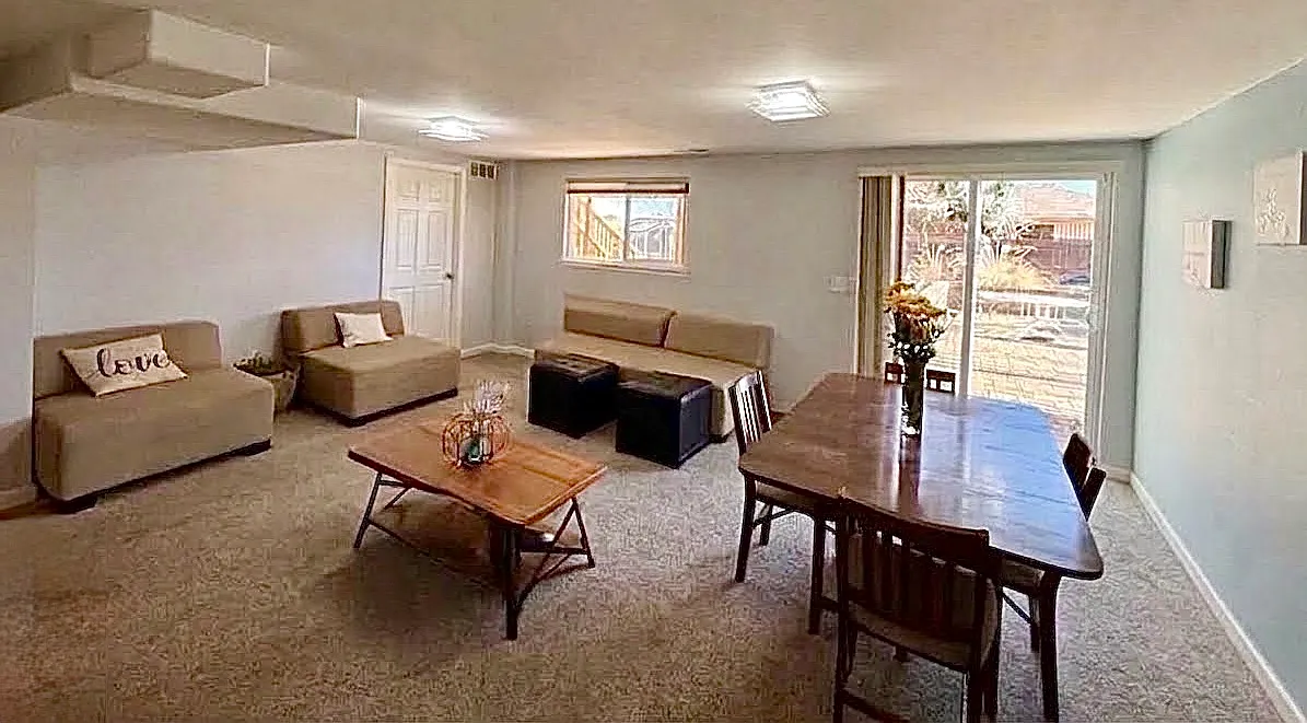 Living and Dining room areas looking outdoors and towards entrance.