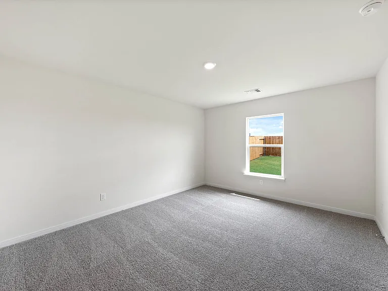 The master bedroom has a large window with great natural light and backyard views.