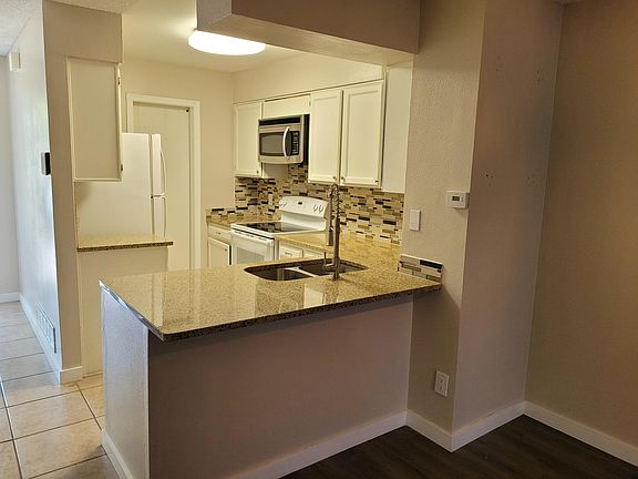 Kitchen with 1/2 bath behind barn door