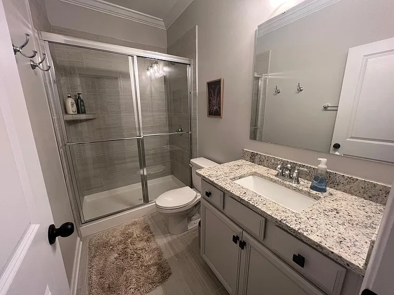 1st floor shared bathroom with walk in shower and granite countertop. Perfect for guests