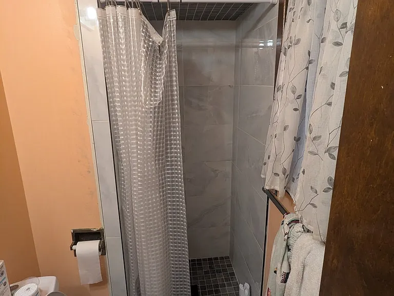 Bedroom #3 with private bathroom view of window, shower and toilet