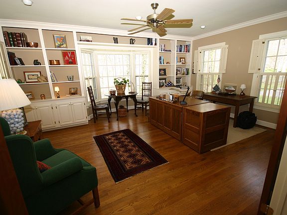 Large office with built-in bookcases and walk-in bay window