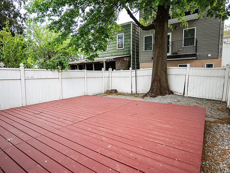 Backyard with deck. Perfect for BBQs & gatherings.
