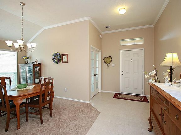 Another view into the foyer, formal dining, and study areas.  Notice the crown molding, tall ceilings, neutral paint color, all to enhance your own style and furnishings.