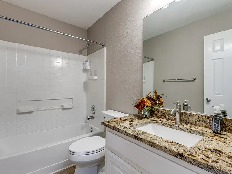 Hall / Guest bath with granite countertops and updated lighting