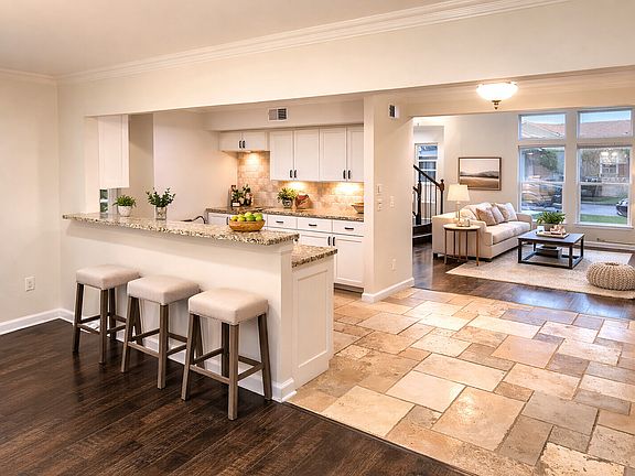 Kitchen overlooking living areas with virtual staging