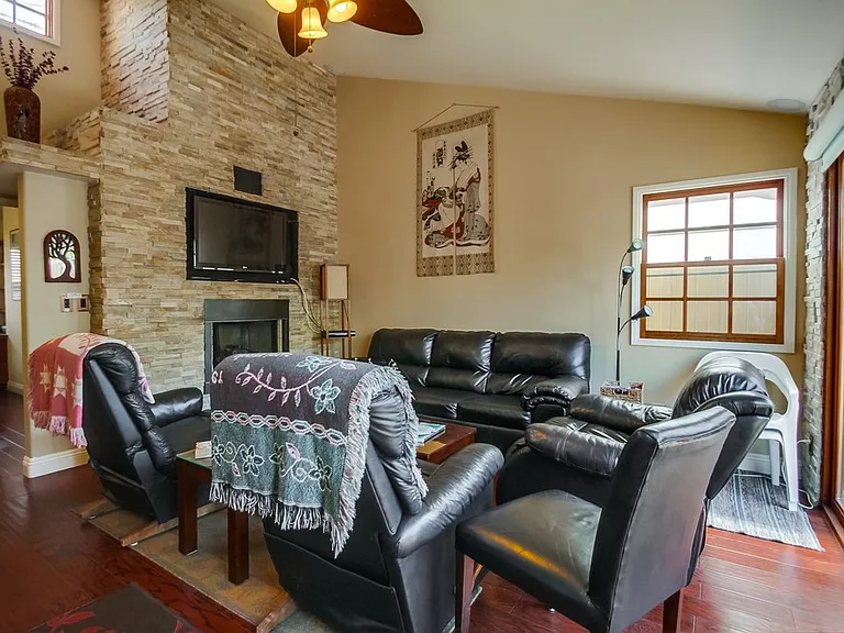 Cathedral ceilings with windows at the top creates spaciousness and light in the living room and dining room