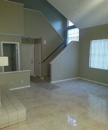 Inside entryway, living area all tiled with stairs to second
