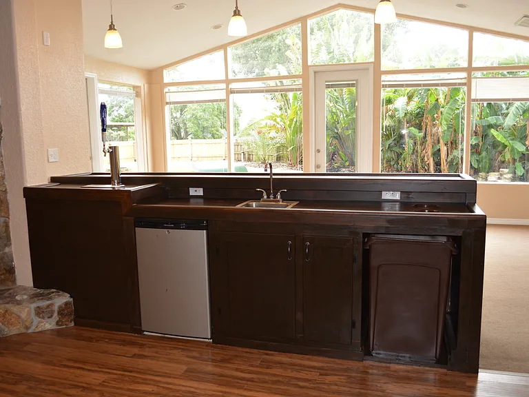 wet bar with mini fridge and kegerator