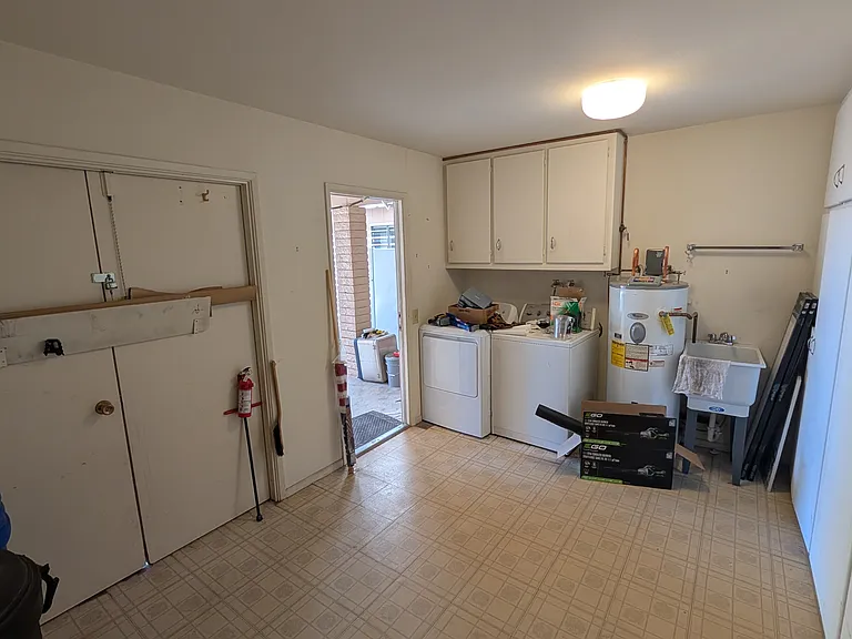 Extra large laundry and storage space. Plenty of room for golf cart, storage and laundry. Built in wall to wall cabinetry also.