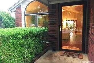 VIEW IN FRONT STORM DOOR. HEDGE HAS BEEN REMOVED.