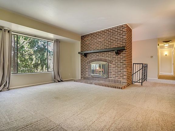 Family room with a cozy wood burning fireplace.
