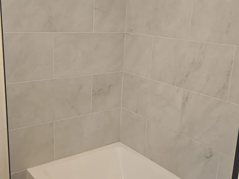New bathtub, tiles and fixtures.